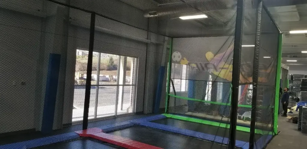Netted trampoline court by the front windows at Valley Jump near Harrisonburg